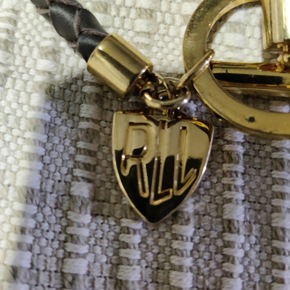 Lauren Ralph Lauren monogrammed braided leather brass charm bracelet.
